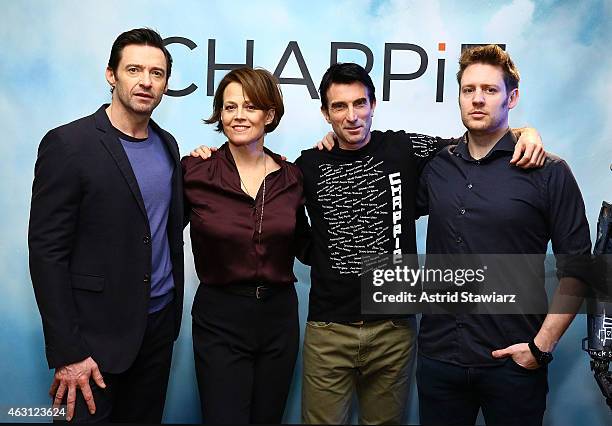 Actors Hugh Jackman, Sigourney Weaver and Sharlto Copley pose with director Neill Blomkamp at the "Chappie" Photocall at Crosby Street Hotel on...