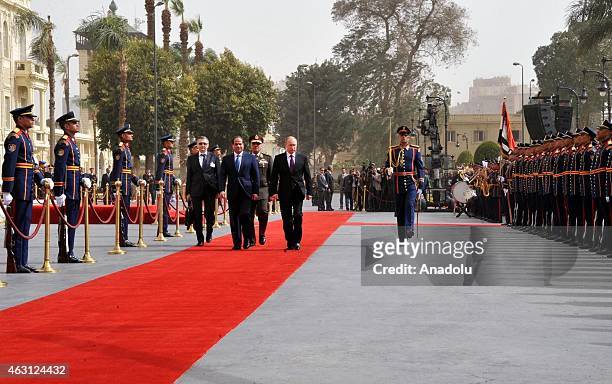 Russian President Vladimir Putin and Egyptian President Abdel Fattah el-Sisi salute Presidential Honor Guards during a welcoming ceremony within...