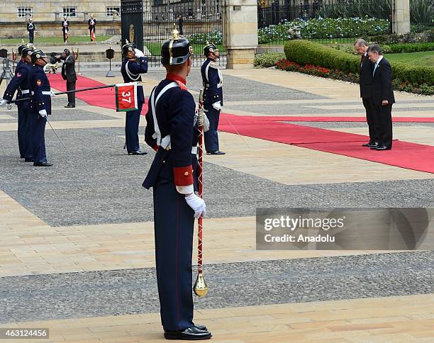 Turkey's President Recep Tayyip Erdogan and Colombian President Juan Manuel Santos review honor guard at Narino Palace in Bogota on February 10,...