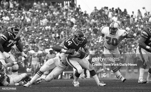 Football New York Jets v Miami Dolphins at Shea Stadium Richard Todd is hit as he rolls back. He fumbled and ball was picked up by Bill Barnett .