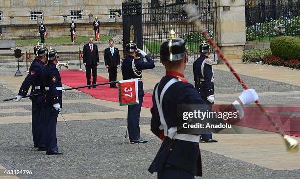 Turkey's President Recep Tayyip Erdogan and Colombian President Juan Manuel Santos review honor guard at Narino Palace in Bogota on February 10,...