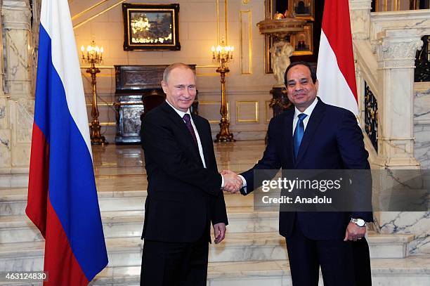 Russian President Vladimir Putin and Egyptian President Abdel Fattah el-Sisi shake hands during a welcoming ceremony within Putin's visit at...