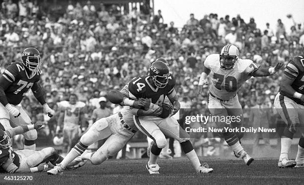 Football New York Jets v Miami Dolphins at Shea Stadium Richard Todd is hit as he rolls back. He fumbled and ball was picked up by Bill Barnett .