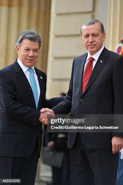 Turkish president Recep Tayyip Erdoga shakes hands with Juan Manuel Santos president of Colombia upon he arrives at Narino Presidential Palace for a...