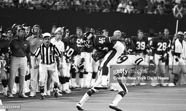 Football New York Giants vs New York Jets Giants' Leon Bright flies through the air after spectacular hit by Jet cornerback Johnny Lynn .