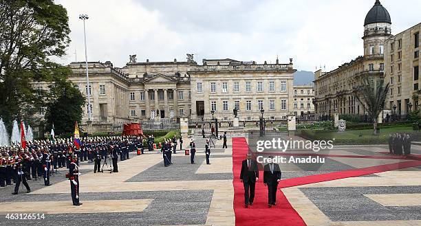 Turkey's President Recep Tayyip Erdogan and Colombian President Juan Manuel Santos review honor guard at Narino Palace in Bogota on February 10,...