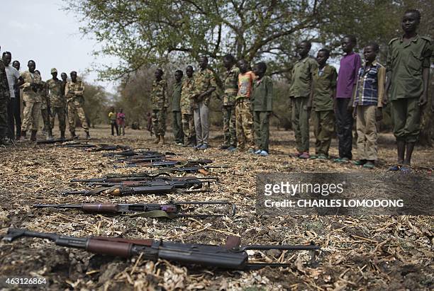 Young boys, children soldiers sit on February 10, 2015 lay down their arms at a ceremony of the child soldiers disarmament, demobilisation and...