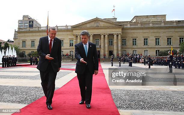 Turkey's President Recep Tayyip Erdogan and Colombian President Juan Manuel Santos review honor guard at Narino Palace in Bogota on February 10,...