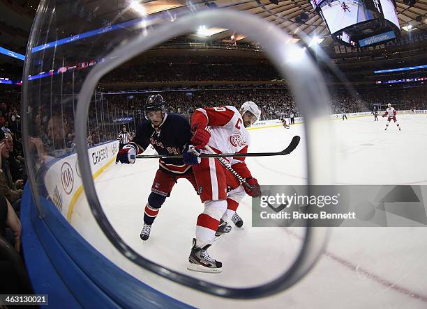 Henrik Zetterberg of the Detroit Red Wings and Derick Brassard of the New York Rangers battle for position at Madison Square Garden on January 16,...