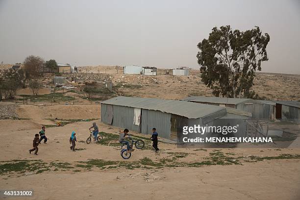 Israeli Bedouin children play in the yard of their home in the Bedouin town of Segev Shalom, in the Negev desert, near the southern Israeli city of...