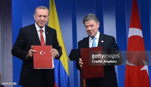 Turkey's President Recep Tayyip Erdogan and Colombian President Juan Manuel Santos sign a cooperation agreement after their meeting in Bogota on...