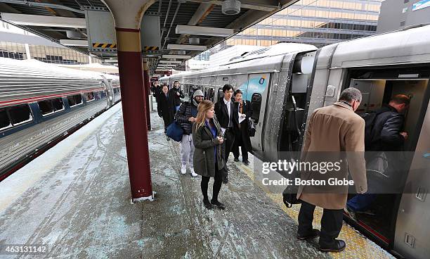 Passengers board Amtrak's 2163 Acela Express to Washington D.C. With the MBTA's train service suspended because of snow conditions, there was little...