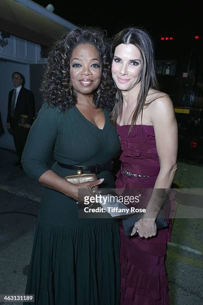 Oprah Winfrey and actrss Sandra Bullock with Champagne Nicolas Feuillatte attend the 19th Annual Critics' Choice Movie Awards at Barker Hangar on...