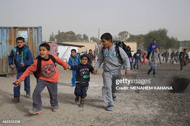 Israeli Bedouin children walk home from school in the Bedouin town of Segev Shalom, in the Negev desert, near the southern Israeli city of Beersheva,...