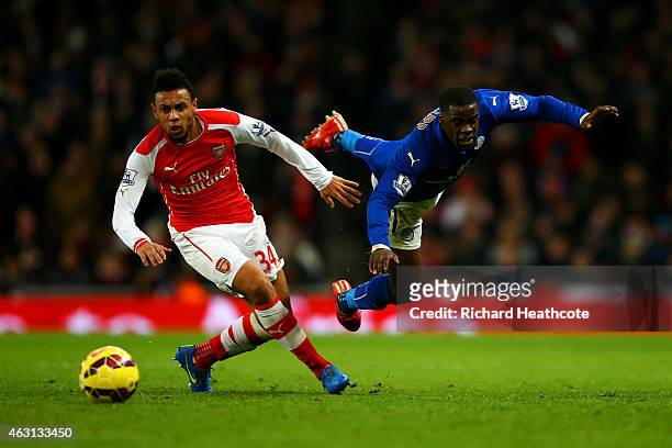 Jeffrey Schlupp of Leicester City battles for the ball with Francis Coquelin of Arsenal during the Barclays Premier League match between Arsenal and...