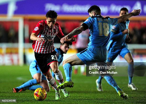 Tom Nichols of Exeter City takes on Michael Nelson of Cambridge United during the Sky Bet League Two match between Exeter City and Cambridge United...