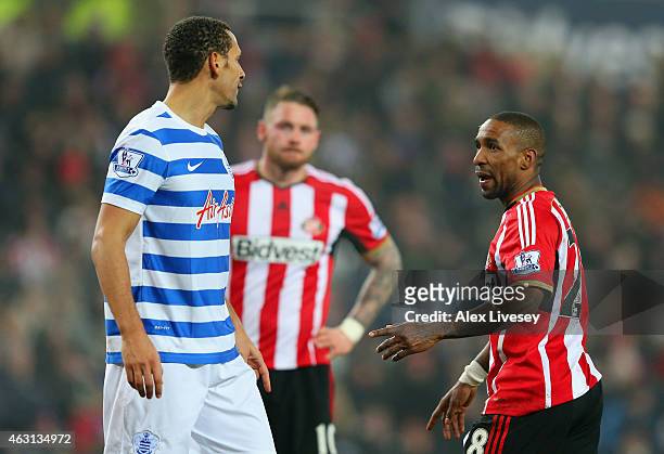 Rio Ferdinand of QPR has with Jermain Defoe of Sunderland during the Barclays Premier League match between Sunderland and Queens Park Rangers at...