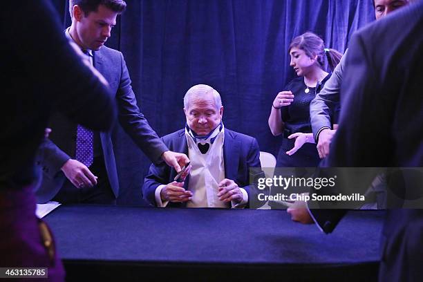 Former US Secretary of Defense Robert Gates finishes signing copies of his new book, "Duty" during an event sponsored by Politico at the Mayflower...