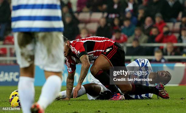 Leroy Fer of Queens Park Rangers is injured in a challenge with Liam Bridcutt of sunderland during the Barclays Premier League match between...