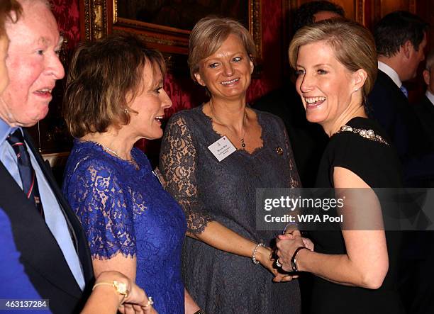 Sophie, Countess of Wessex meets television presenters Alice Beer and Esther Rantzen during a reception to celebrate the patronages & affiliations of...