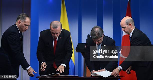 Turkey's President Recep Tayyip Erdogan and Colombian President Juan Manuel Santos sign a cooperation agreement after their meeting in Bogota on...