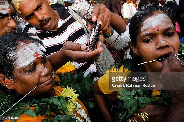 Female devotees pierce their tongues during the Thaipusam festival on January 17, 2014 in Kuala Lumpur. Thaipusam is a Hindu festival celebrated on...