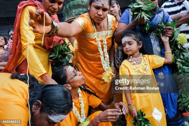 Family of devotees prepare their offering during the Thaipusam festival on January 17, 2014 in Kuala Lumpur. Thaipusam is a Hindu festival celebrated...