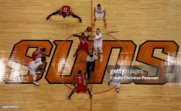 Joey Dorsey of the Houston Rockets and Miles Plumlee of the Phoenix Suns jump for the openning tip off during the NBA game at US Airways Center on...