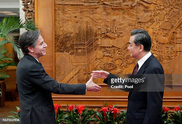 Deputy Secretary of State Antony Blinken shakes hand with Chinese Foreign Minister Wang Yi at the Olive Hall before a meeting at the Foreign Ministry...