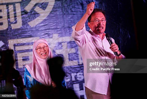 Malaysian opposition leader Anwar Ibrahim with his wife gestures while addressing his supporters at a gathering in Kuala Lumpur Malaysia's highest...