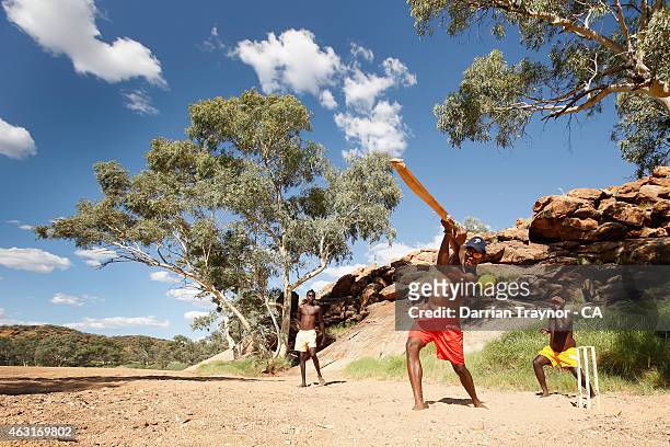 Dale Dhamarrandji from Gapuwiyak, Arnhem Land in the Northern Territory plays cricket in the dry Todd River with his Miwatj Dolphins team mates...