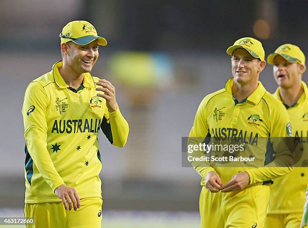 Steven Smith and George Bailey look towards captain Michael Clarke of Australia as they leave the field after winning the Cricket World Cup warm up...