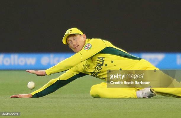 George Bailey of Australia dives unsuccessfully for a catch in the field during the Cricket World Cup warm up match between Australia and the United...