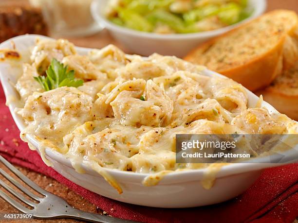 baked tortellini in alfredo sauce - garlic bread stock pictures, royalty-free photos & images