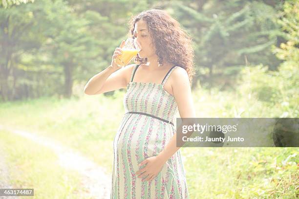 Pregnant Woman Drinking Orange Juice High-Res Stock Photo