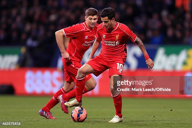 Philippe Coutinho of Liverpool holds the ball up as Steven Gerrard of Liverpool makes a run during the FA Cup Fourth Round Replay match between...