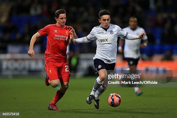 Joe Allen of Liverpool battles with Zach Clough of Bolton during the FA Cup Fourth Round Replay match between Bolton Wanderers and Liverpool at the...