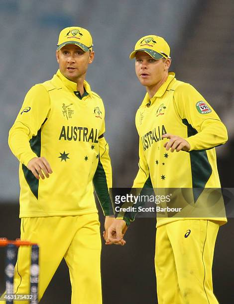Steven Smith and captain Michael Clarke of Australia talk in the field during the Cricket World Cup warm up match between Australia and the United...