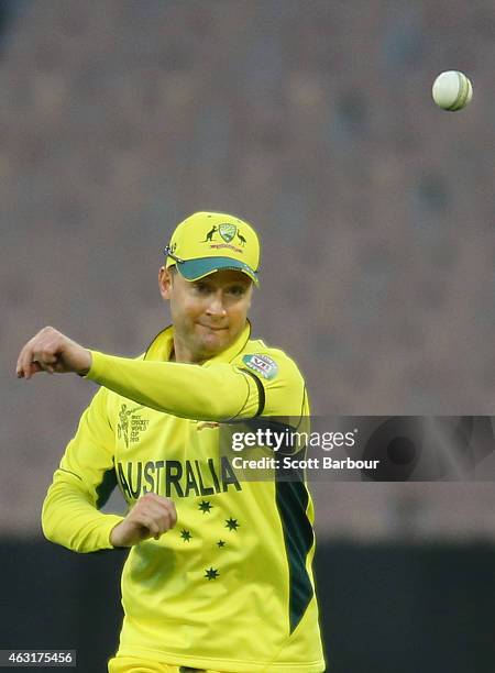 Michael Clarke of Australia throws the ball while in the field during the Cricket World Cup warm up match between Australia and the United Arab...