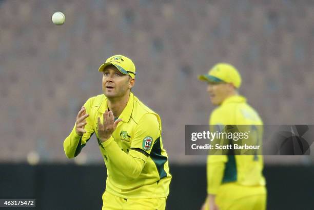 Michael Clarke catches the ball while in the field as George Bailey of Australia looks on during the Cricket World Cup warm up match between...