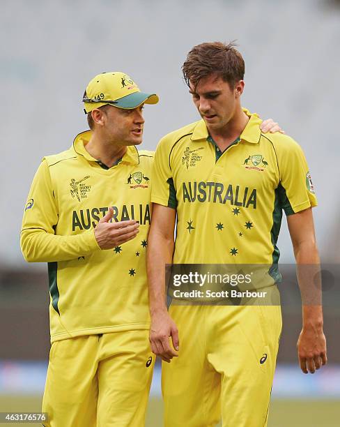 Michael Clarke talks to bowler Pat Cummins of Australia during the Cricket World Cup warm up match between Australia and the United Arab Emirates at...