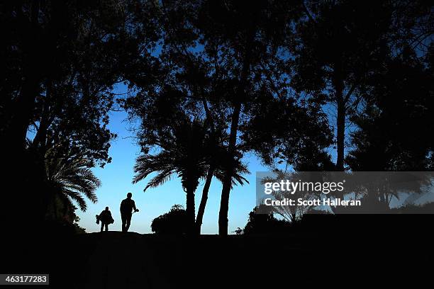 Paul McGinley of Ireland walks with his caddie to the 14th hole during the second round of the Abu Dhabi HSBC Golf Championship at the Abu Dhabi Golf...