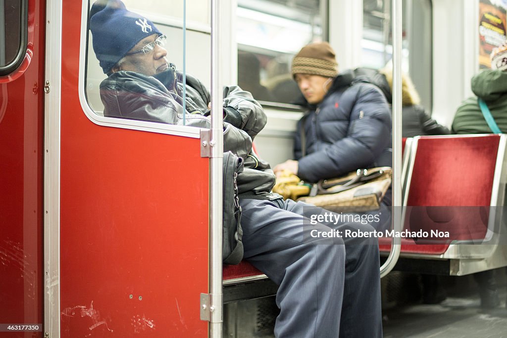 Real life scene of the people riding the Toronto subway, two...