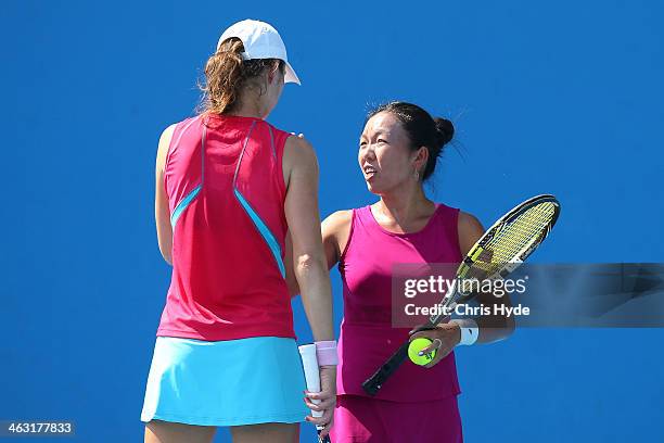 Vania King of the United States and Galina Voskoboeva of Kazakhstan talk tactics in their second round doubles match against Lucie Hradecka of the...