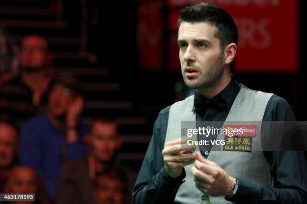 Mark Selby of England reacts against John Higgins of Scotland on day five of the 2014 Dafabet Masters at the Alexandra Palace on January 16, 2014 in...