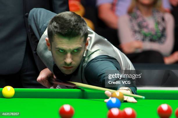 Mark Selby of England plays a shot against John Higgins of Scotland on day five of the 2014 Dafabet Masters at the Alexandra Palace on January 16,...