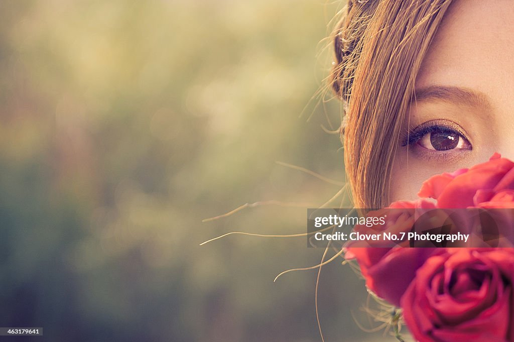 Beautiful girl and red roses.