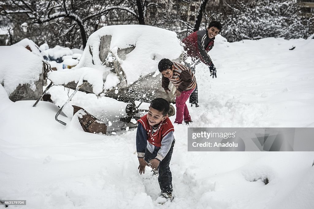A group of Syrian refugees struggle with cold in Ankara