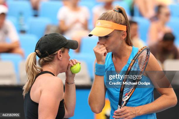 Daniela Hantuchova of Slovakia and Lisa Raymond of the United States talk tactics in their first round doubles match against Mandy Minella of...