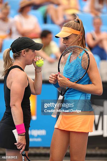 Daniela Hantuchova of Slovakia and Lisa Raymond of the United States talk tactics in their first round doubles match against Mandy Minella of...